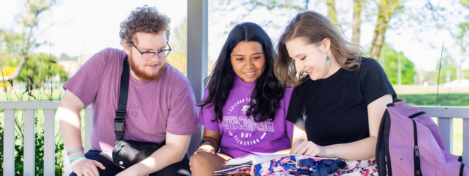 group of students concentrate on chemistry experiment