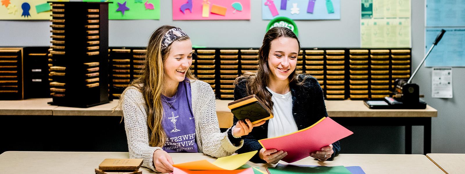 female college student reads book to young boy